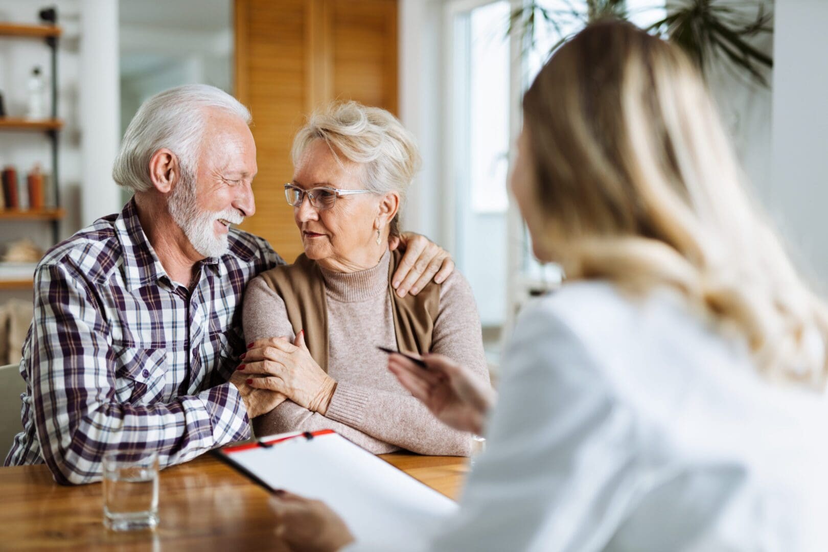 Elderly couple consulting with a professional.