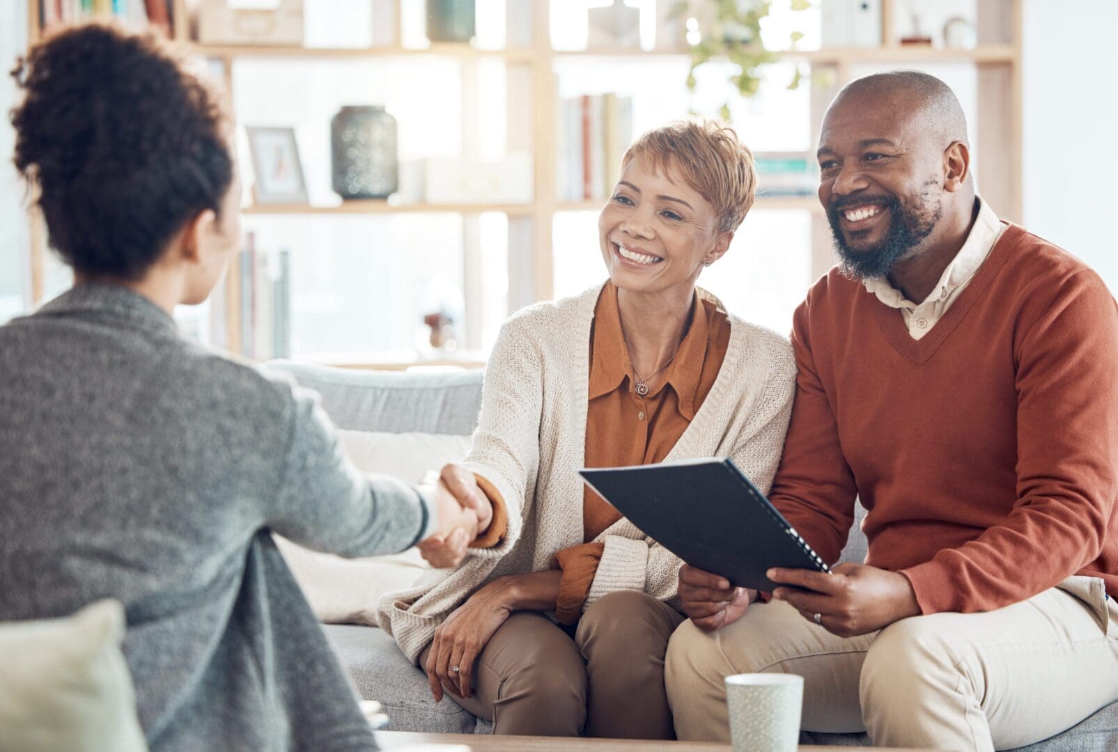 Couple meeting with a professional, smiling.